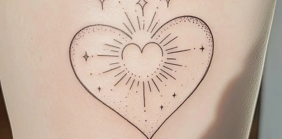 Fine-line heart tattoo on healing skin