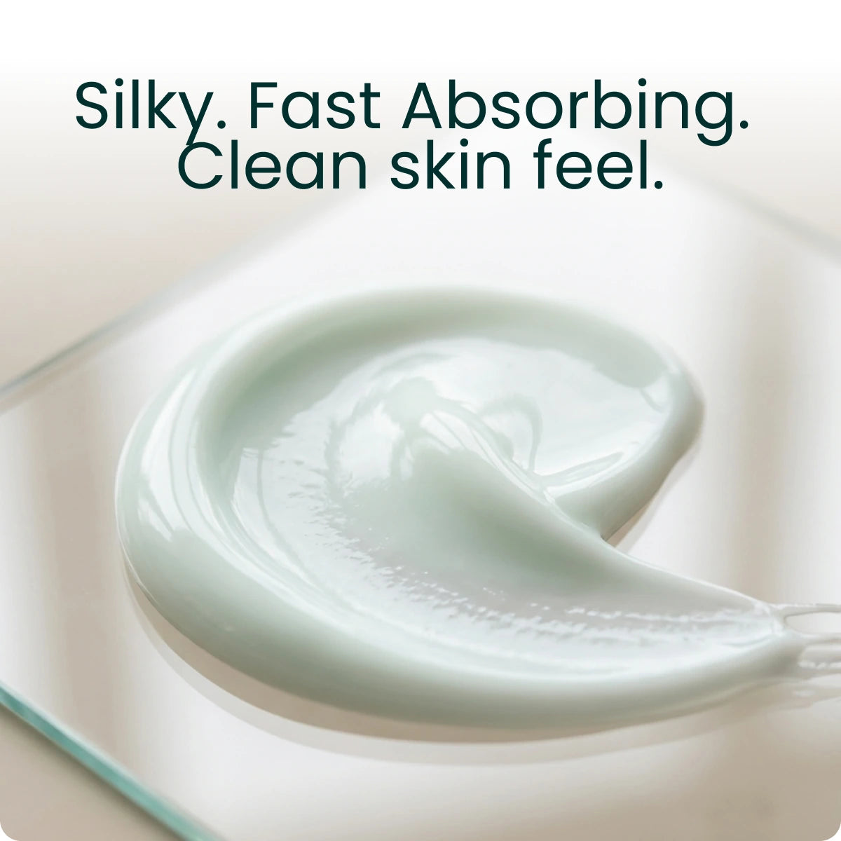 A swirl of white lotion, captioned "Silky. Fast Absorbing. Clean skin feel."