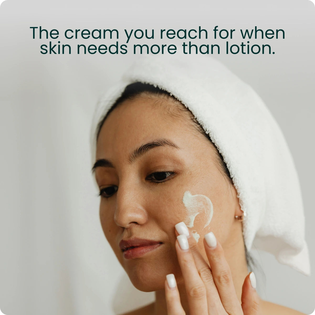 A woman in a hair towel applying cream, captioned "The cream you reach for when skin needs more than lotion."