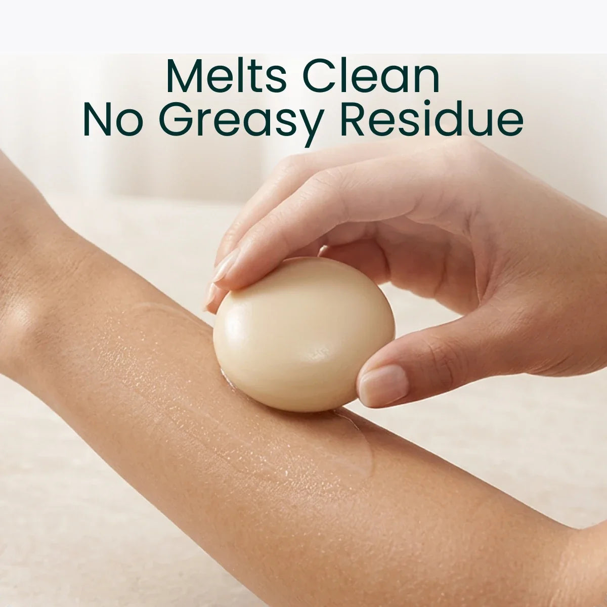 A hand gliding the Body Stone along a forearm, captioned "Melts Clean, No Greasy Residue"