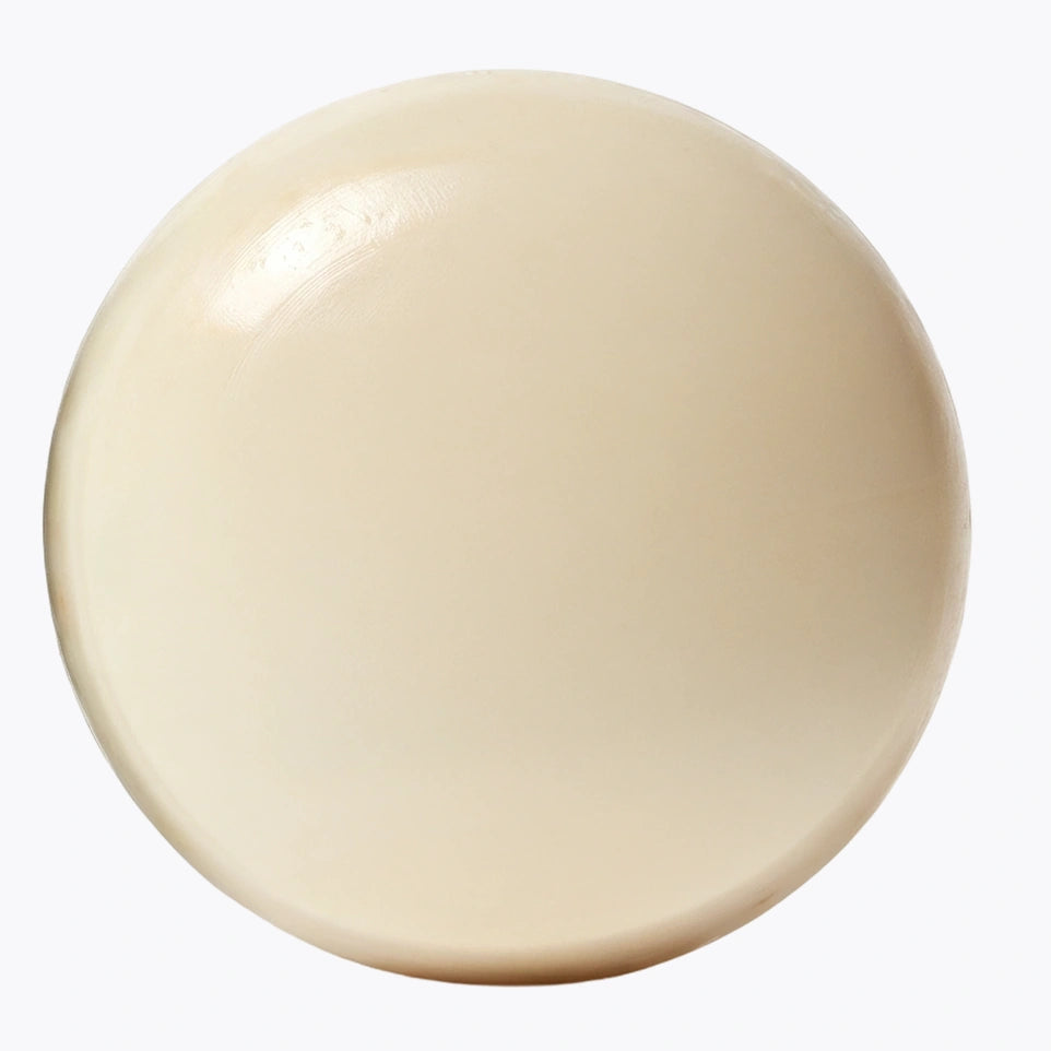 The Emu Joy Body Stone lotion bar, a smooth cream-coloured disc, on a pale grey background