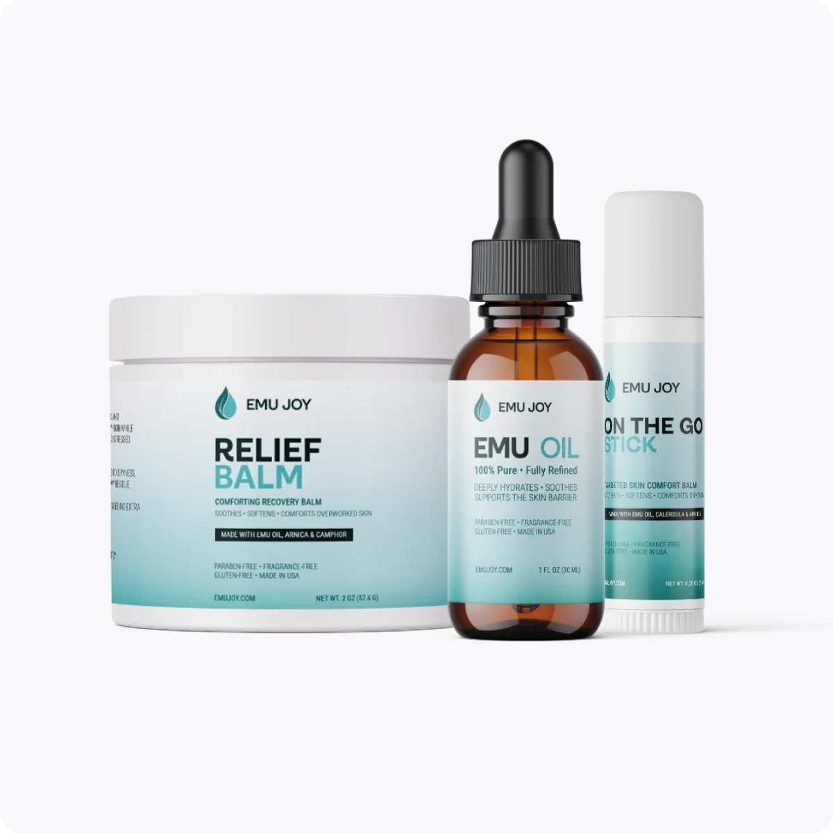 The Soothe My Pain Kit lineup: Relief Balm jar, Emu Oil bottle and On The Go Stick
