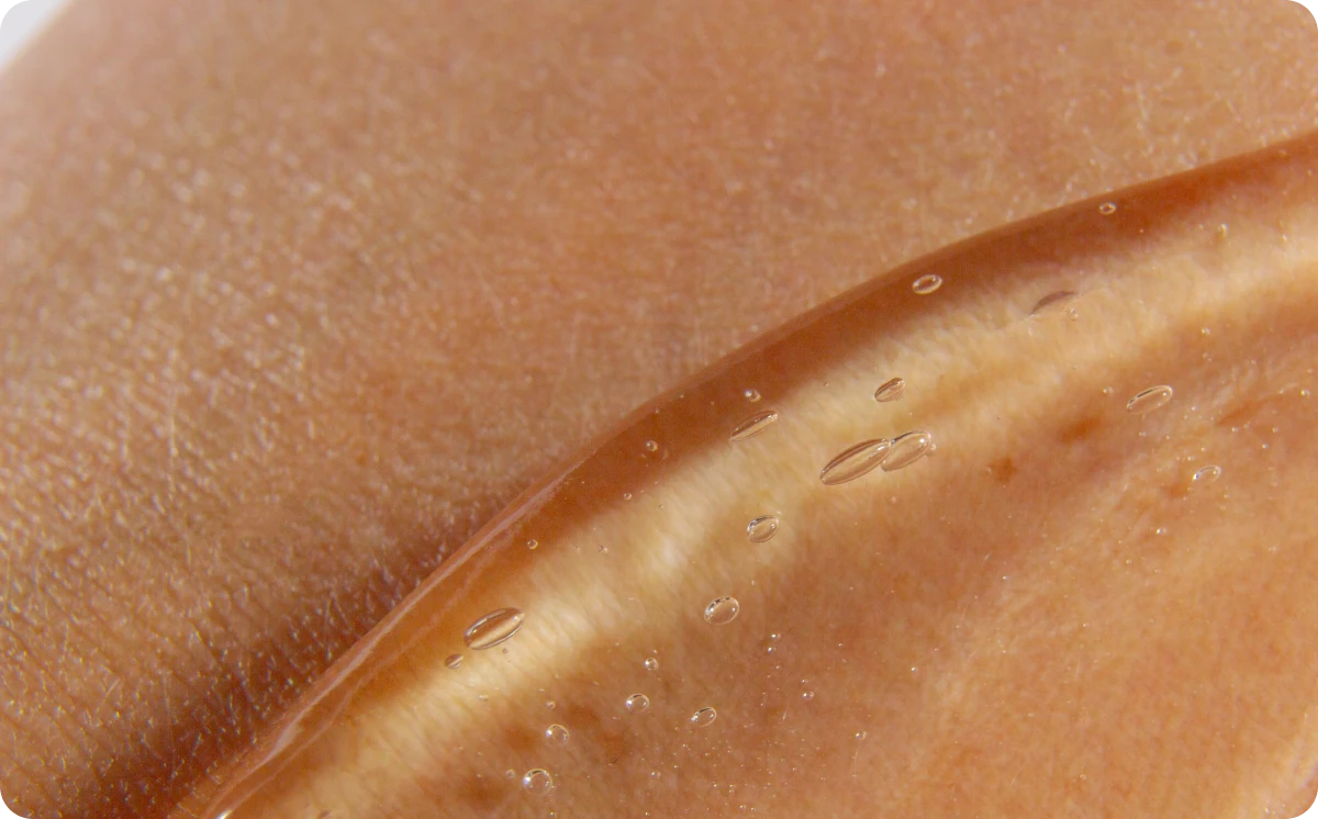 Emu oil spread across skin in a translucent layer