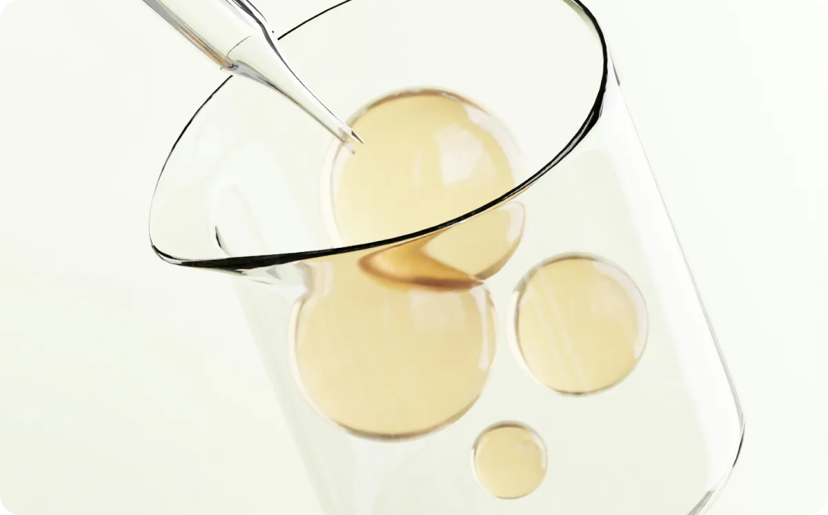 Laboratory beaker with droplets of emu oil and a glass stirring rod