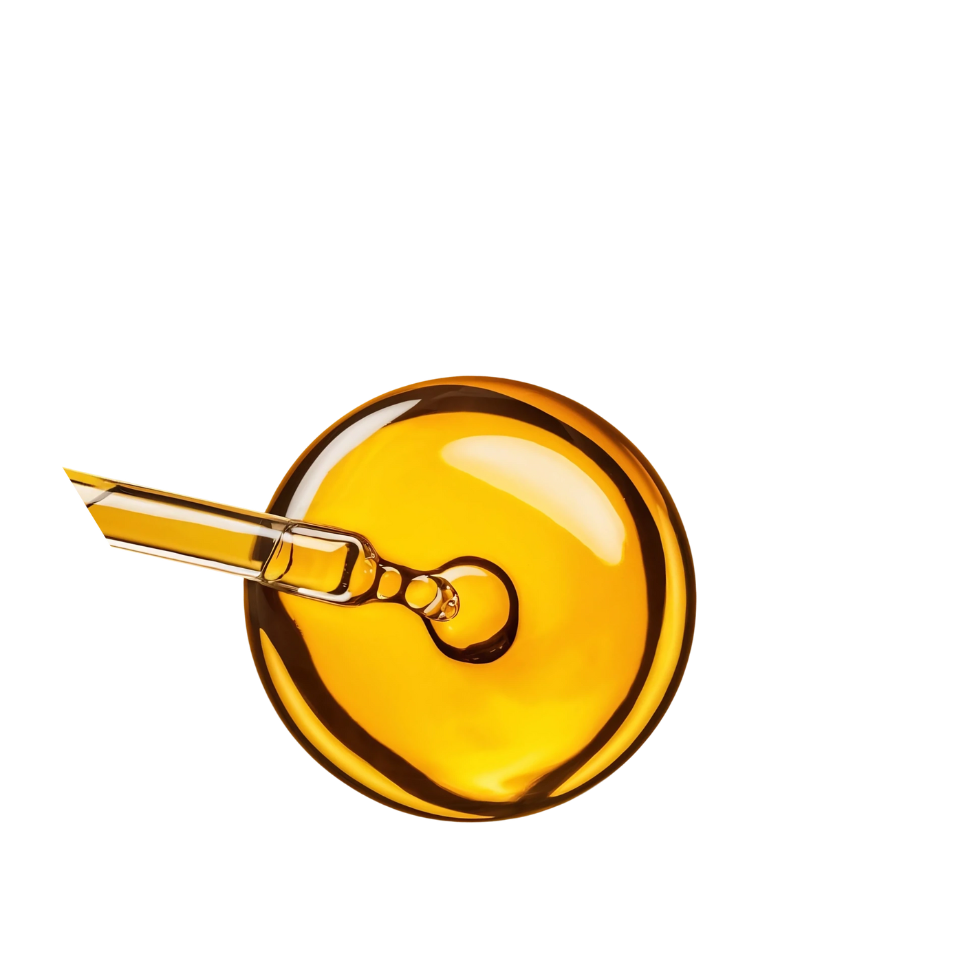 A glass dropper resting on a golden pool of emu oil