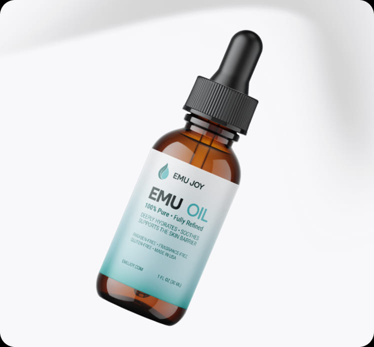 Emu Joy Emu Oil dropper bottle resting on a white surface
