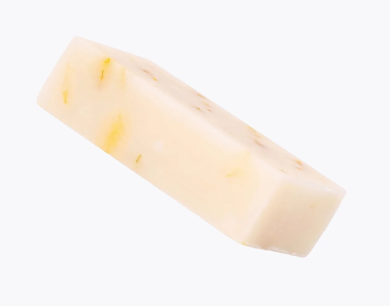 The Emu Joy Emu Oil Soap bar angled on a pale grey background, calendula petals visible through the bar